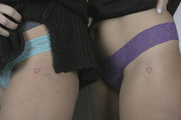 Tiny matching heart tattoos by Lindsay April
