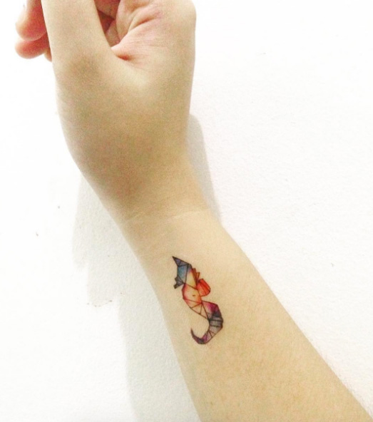Tiny seahorse on wrist by Tattoooie