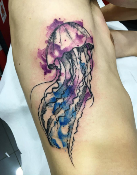 Large watercolor jellyfish tattoo on rib cage by Sandro Stagnitta