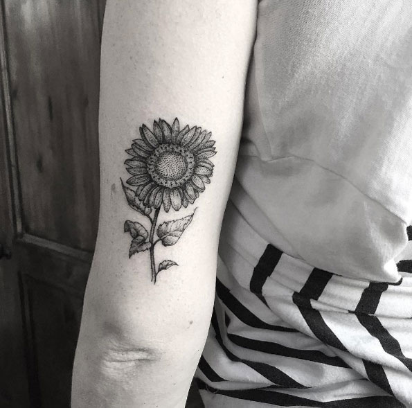 Blackwork back arm sunflower tattoo by Annita Maslov