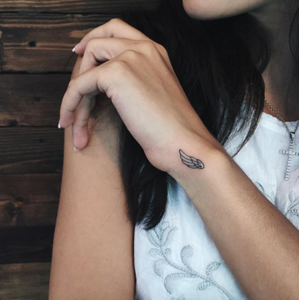 Tiny Wing Tattoo on Wrist by Sasha Masiuk