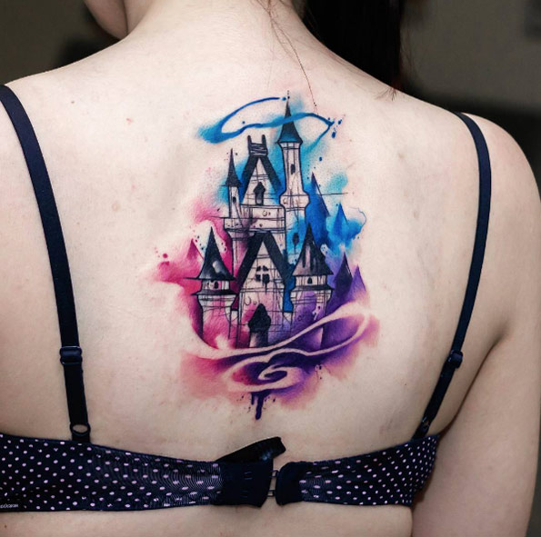 Watercolor Disney castle tattoo on back by Uncl Paul Knows