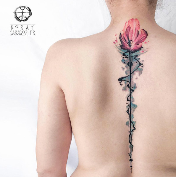 Breathtaking blooming tulip tattoo on back by Koray Karagozler