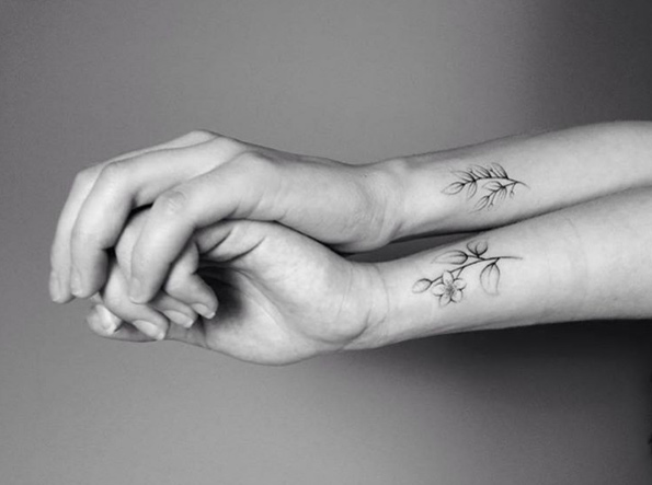 Floral sister tats on wrists by Lara Maju