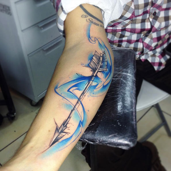 Swirling watercolor arrow tattoo by Adrian Bascur