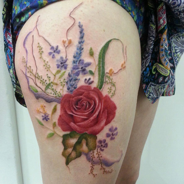 Rose tattoo with extras on thigh by Jemka