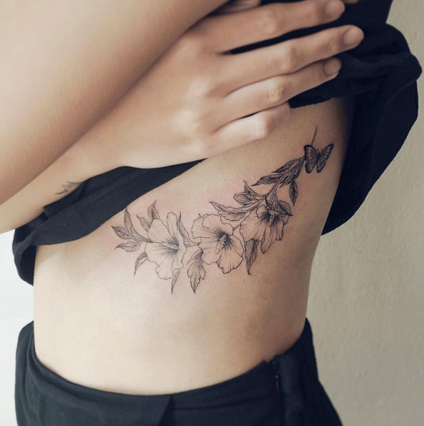 Blackwork florals on rib cage by Sol Tattoo