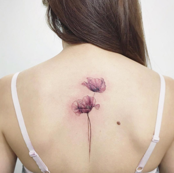 Delicate flowers on back by Tattooist Flower