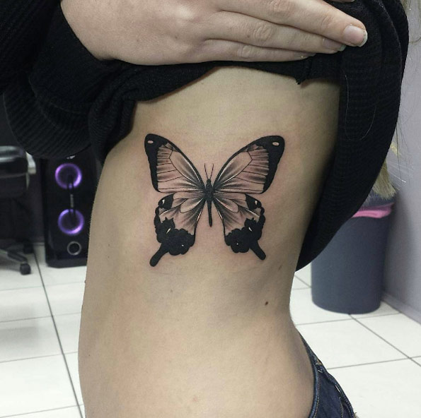 Beautiful blackwork butterfly tattoo by Joel