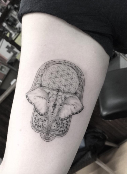 Elephant-infused hamsa hand tattoo by Doctor Woo