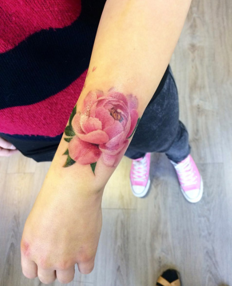 Lovely pink peony on wrist by Suvi Alalantela