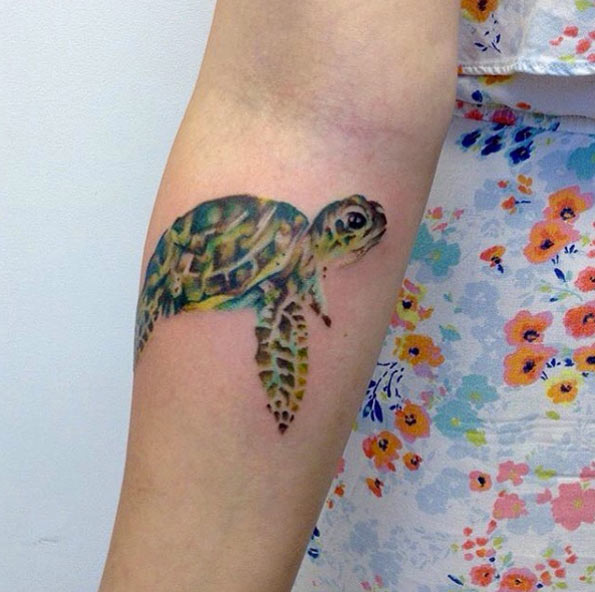 Watercolor sea turtle on forearm by Looking Glass Tattoos