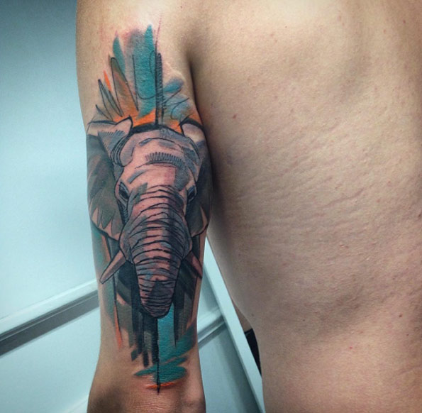 Watercolor elephant tattoo on tricep by Szabi