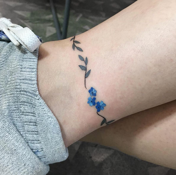 Adorable floral anklet tattoo by Zihee