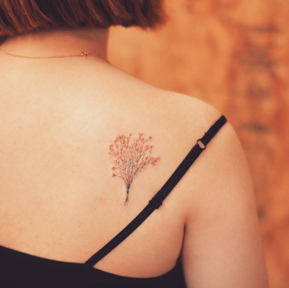Baby's Breath tattoo on back shoulder by Tattooist Grain