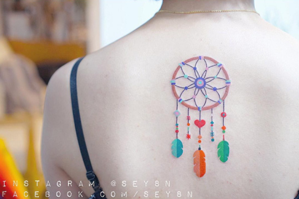 Beautifully colored dreamcatcher tattoo by Seyoon Gim