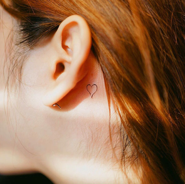 Behind-the-ear heart tattoo by Nando