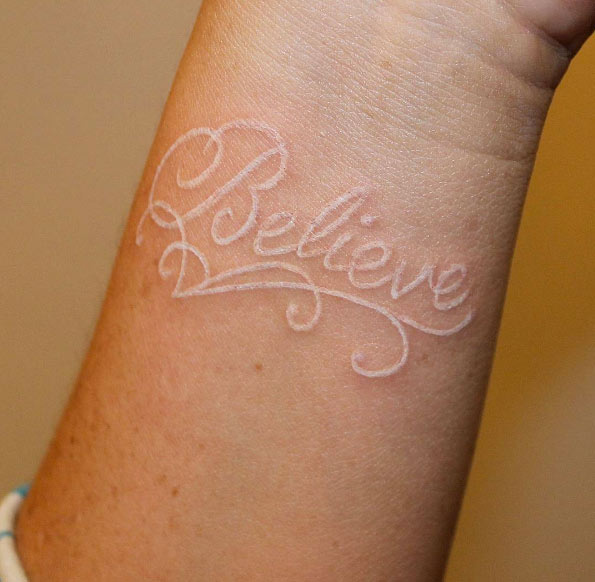 'Believe' white ink wrist tattoo by Gutta Banks 