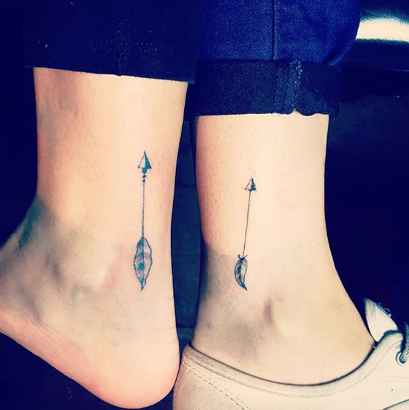 Matching ankle arrow tattoos by via Carol Rossetti