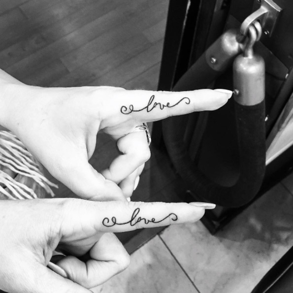 'Love' finger tats by Channing Artist
