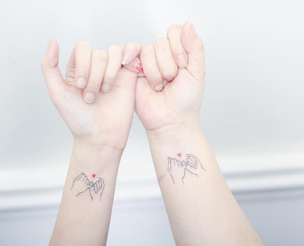 Matching hearted pinky promise tattoos by Mini Lau