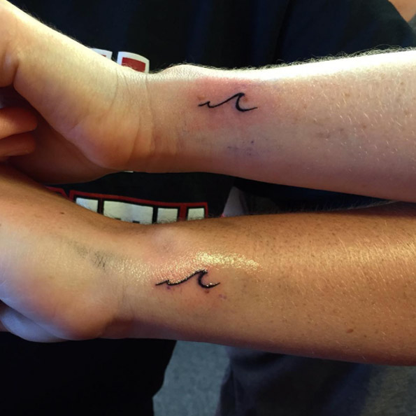 Matching tiny wave tattoos on wrist by Rebecca Fedun