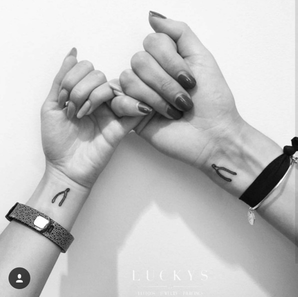 Wishbone wrist tattoos by Lucky's