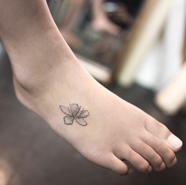 Black and grey ink cherry blossom tattoo on foot by Hongdam