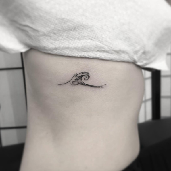 Small blackwork wave tattoo by OK