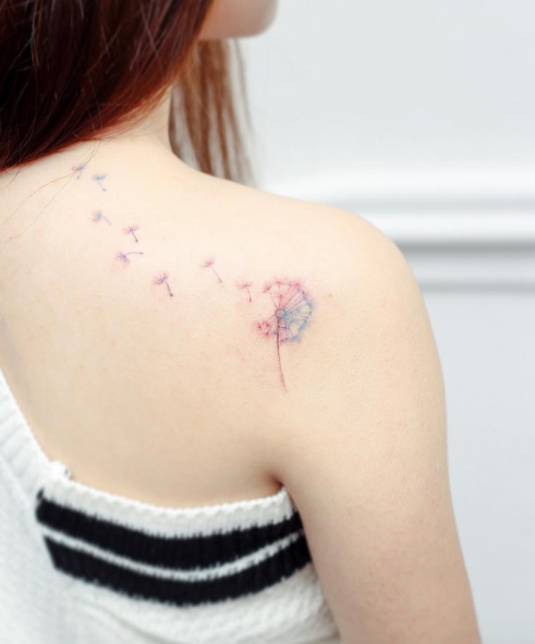 Colorful dandelion tattoo by Hello Tattoo