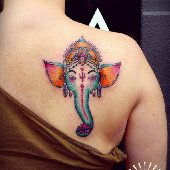 Colorful Ganesh tattoo on back shoulder by Cynthia Sobraty