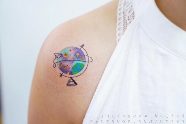 Travel-themed globe tattoo by Sey8n