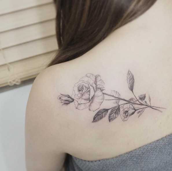 Delicate blackwork rose tattoo on back shoulder by Tattooist Flower