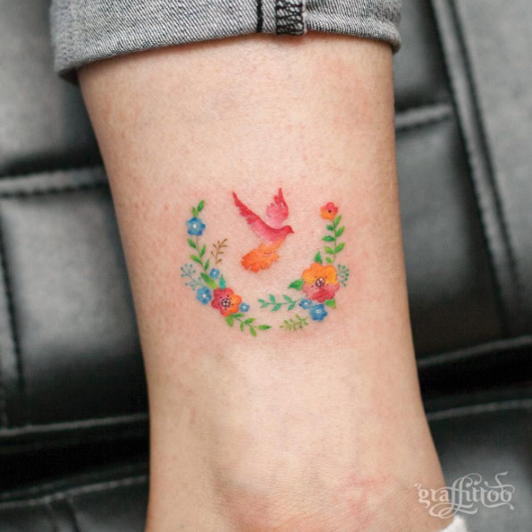 Colorful floral bird tattoo by Tattooist River