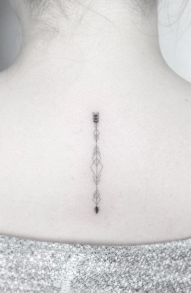 Small geometric arrow tattoo by Jakub Nowicz