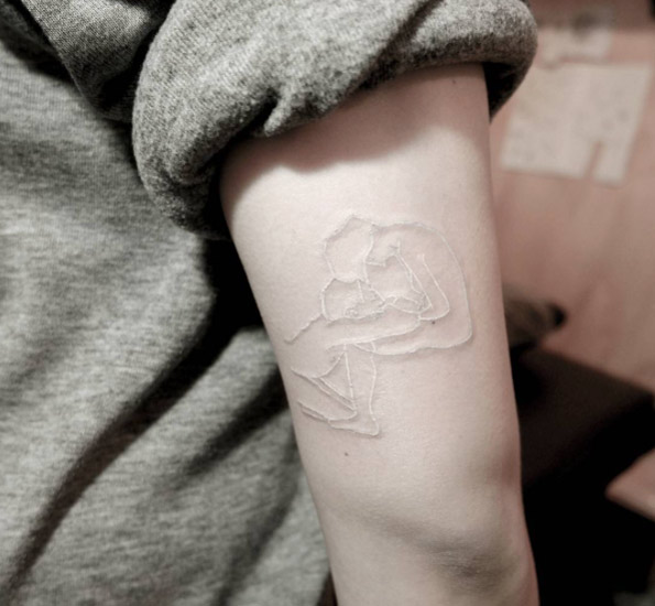 Gorgeous white ink tricep tattoo by Chaewa