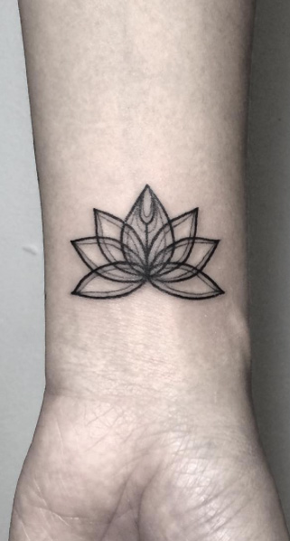 Lotus flower on wrist by Fin Tattoos