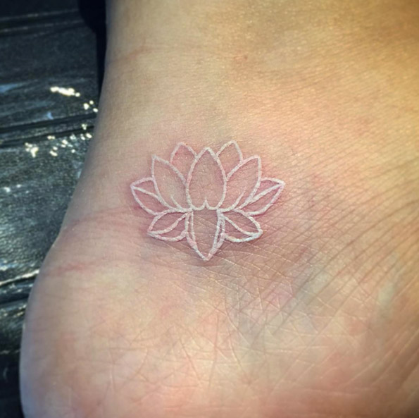 Lotus flower white ink tattoo on ankle by Brandon