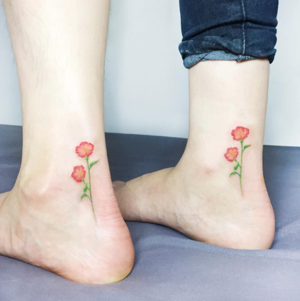 Matching floral ankle tattoos by IDA