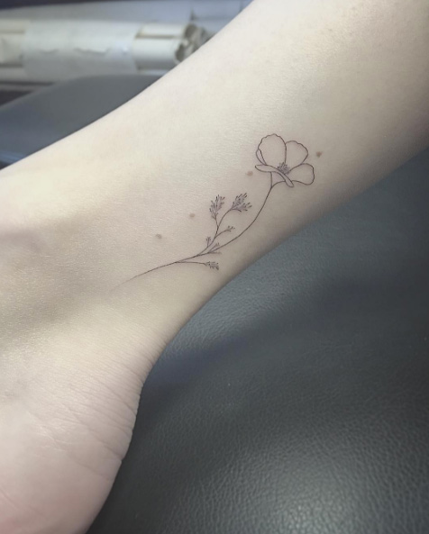 Minimalistic flower tattoo on ankle by East Iz