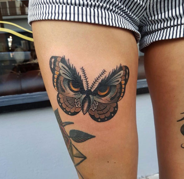 Owl-esque butterfly tattoo by Chris Stockings