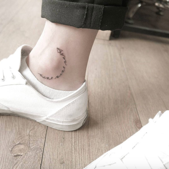 Tiny paper airplane ankle tattoo by Chaewa