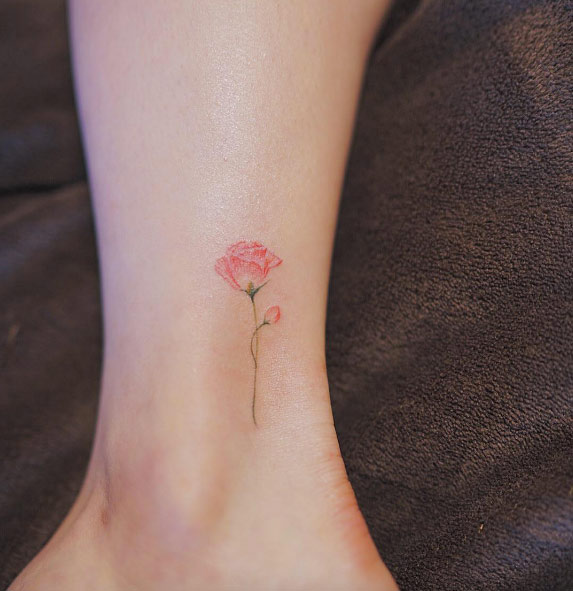 Tiny rose tattoo on ankle by Nando