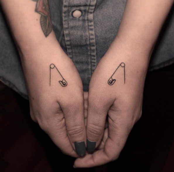 Matching safety pin tattoos by Brandon