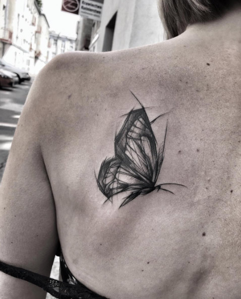 Sketch style butterfly tattoo on back shoulder by Inez Janiak