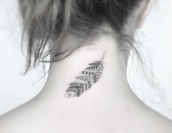 Small blackwork Indian feather tattoo on back neck by Jakub Nowicz