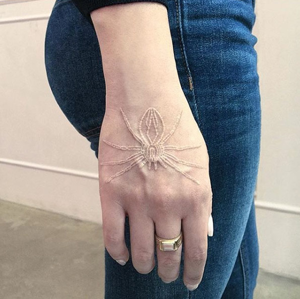 White ink spider tattoo on hand by Mirko Sata
