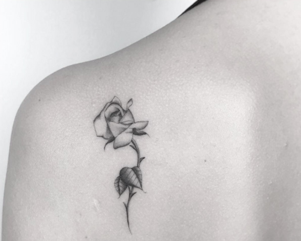 Tiny blackwork rose tattoo by Jakub Nowicz