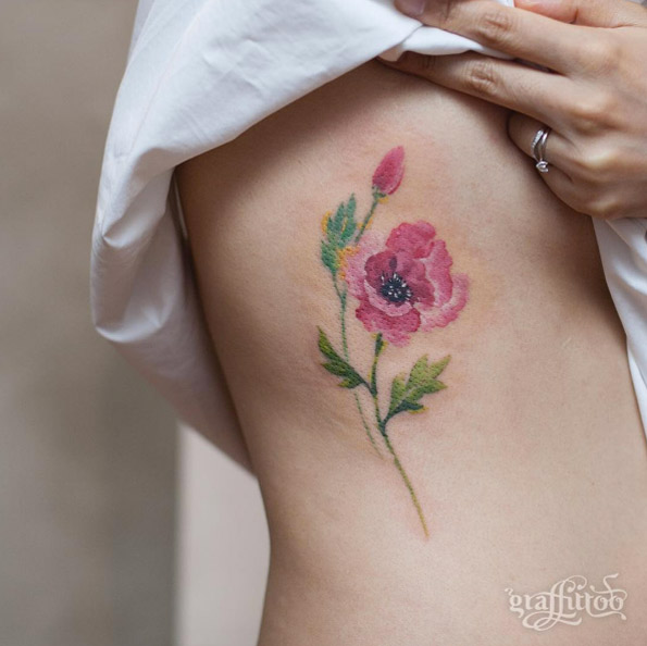 Lovely watercolor flower tattoo on rib cage by Tattooist River