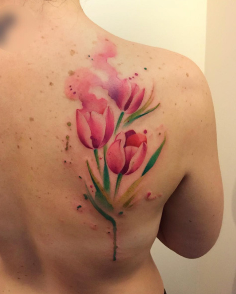 Watercolor tulips on back shoulder by Bora Tattoo